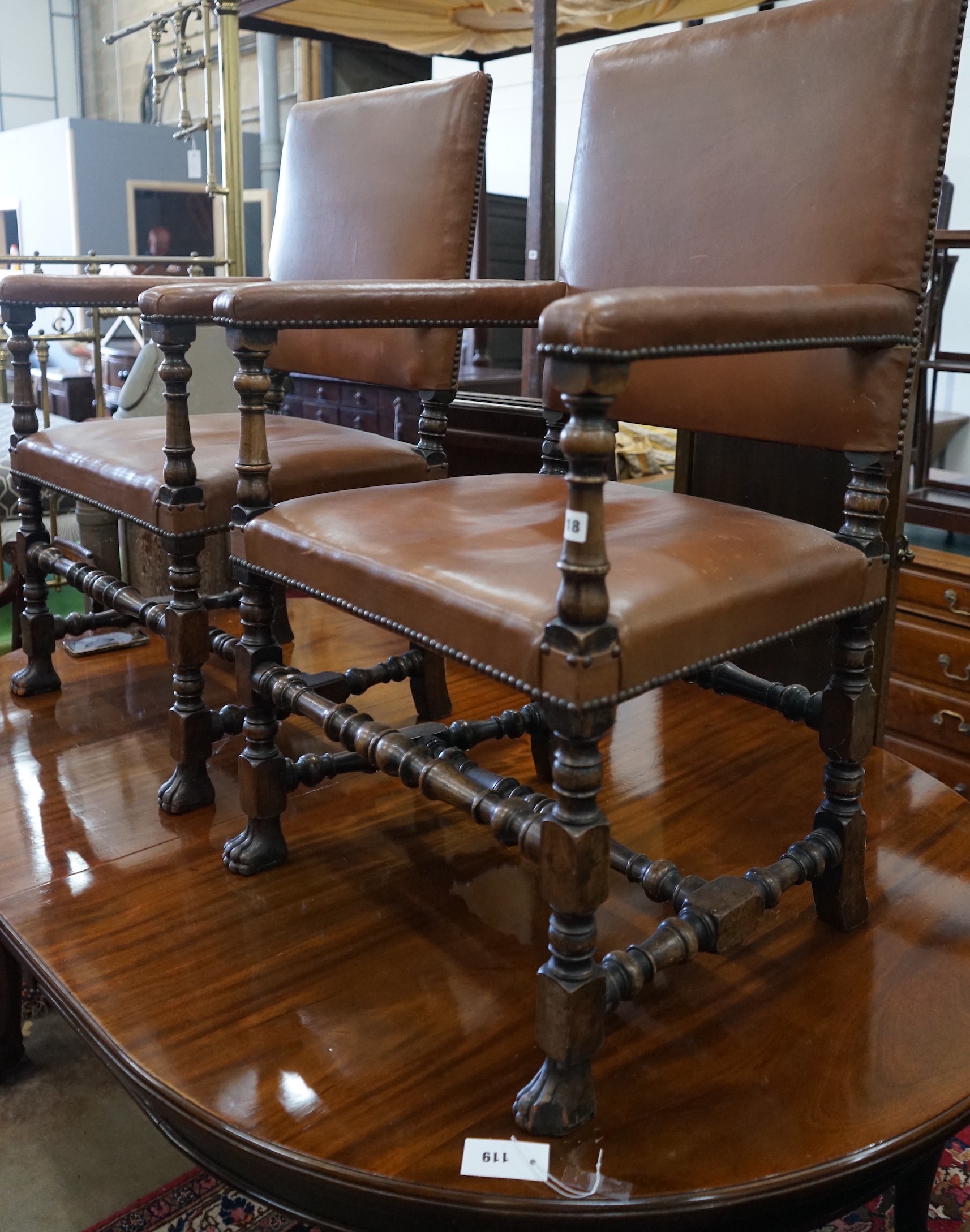 A pair of 1920's Carolean style walnut elbow chairs, width 62cm, depth 47cm, height 100cm